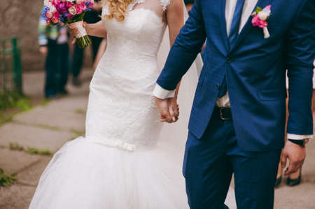 Holding hands. Closeup view of married couple holding handsの写真素材