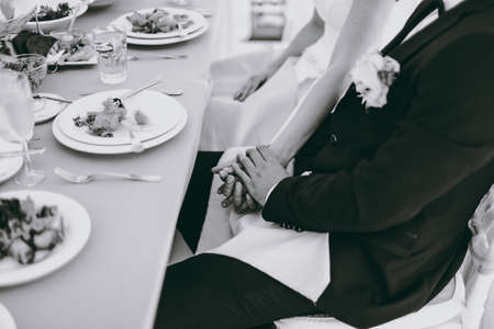 Holding hands. Closeup view of married couple holding handsの写真素材