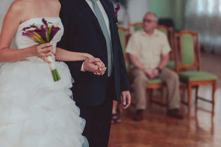 Holding hands. Closeup view of married couple holding handsの写真素材