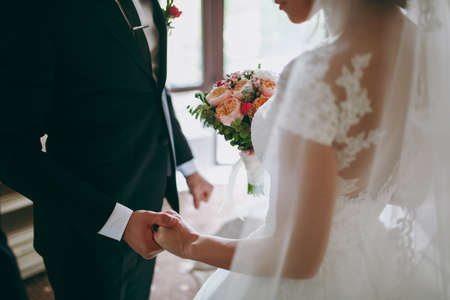 Holding hands. Closeup view of married couple holding handsの写真素材