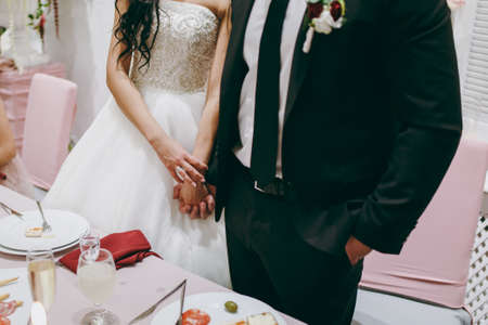 Holding hands. Closeup view of married couple holding handsの写真素材
