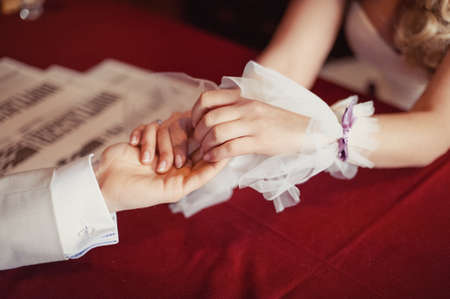 Holding hands. Closeup view of married couple holding handsの写真素材