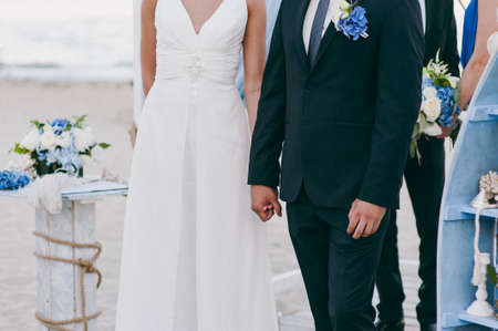 Holding hands. Closeup view of married couple holding handsの写真素材