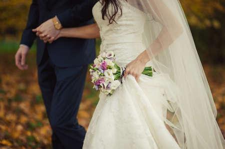 Holding hands. Closeup view of married couple holding handsの写真素材