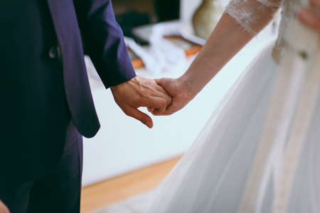 Holding hands. Closeup view of married couple holding handsの写真素材