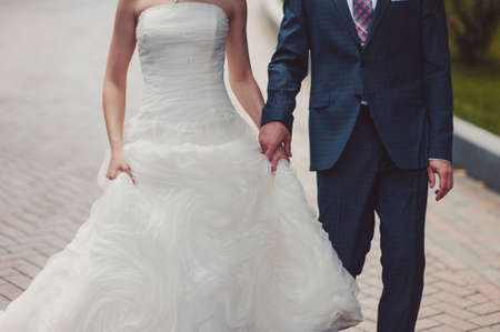 Holding hands. Closeup view of married couple holding handsの写真素材
