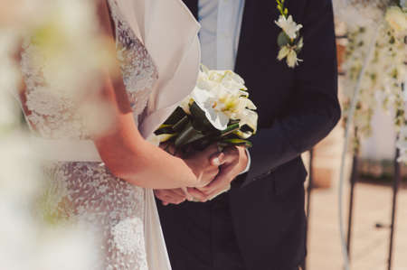 Holding hands. Closeup view of married couple holding handsの写真素材