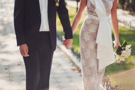 Holding hands. Closeup view of married couple holding handsの写真素材