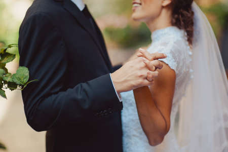 Holding hands. Closeup view of married couple holding handsの写真素材