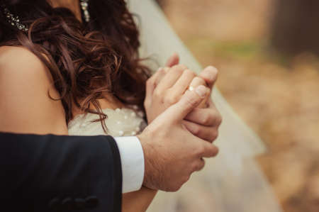 Holding hands. Closeup view of married couple holding handsの写真素材