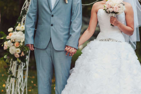 Holding hands. Closeup view of married couple holding handsの写真素材