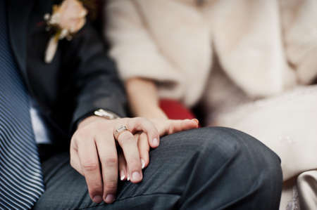 Holding hands. Closeup view of married couple holding handsの写真素材