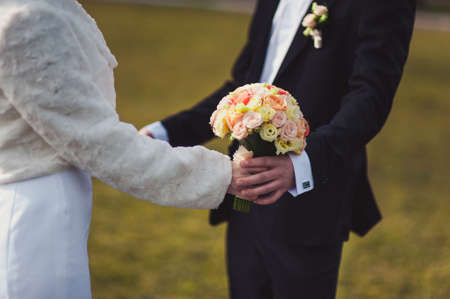 Holding hands. Closeup view of married couple holding handsの写真素材