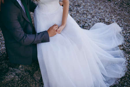 Holding hands. Closeup view of married couple holding handsの写真素材