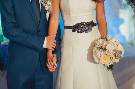 Holding hands. Closeup view of married couple holding handsの写真素材