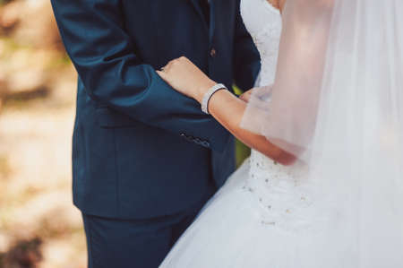 Holding hands. Closeup view of married couple holding handsの写真素材
