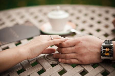 Holding hands. Closeup view of married couple holding handsの写真素材