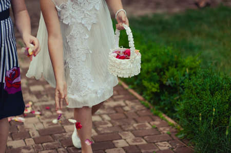 Little bridesmaid with a basket of rose petalsの写真素材