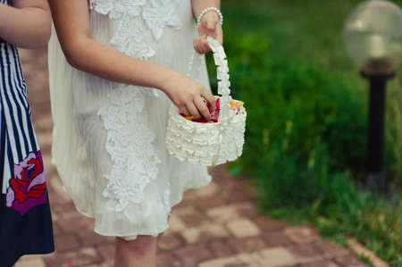 Little bridesmaid with a basket of rose petalsの写真素材