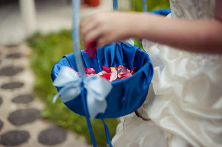 Little bridesmaid with a basket of rose petalsの写真素材