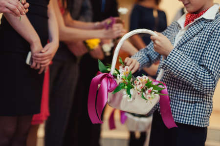 Little bridesmaid with a basket of rose petalsの写真素材