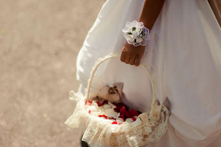Little bridesmaid with a basket of rose petalsの写真素材
