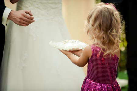 little girl or boy Carrying Wedding Ring On Cushionの写真素材