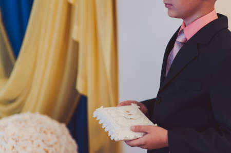 little girl or boy Carrying Wedding Ring On Cushionの写真素材