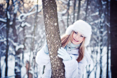 The beautiful girl in a winter snowy parkの写真素材