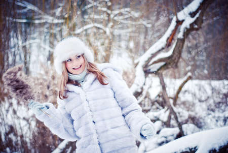 The beautiful girl in a winter snowy parkの写真素材