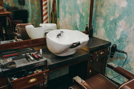 The workplace with a washbasin in barbershop. Interior of luxury beauty salon.の写真素材