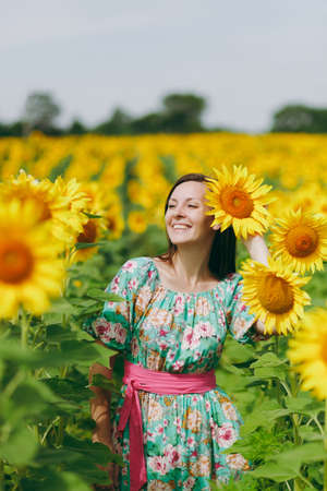 The brunette girl in a field of sunflowersの写真素材