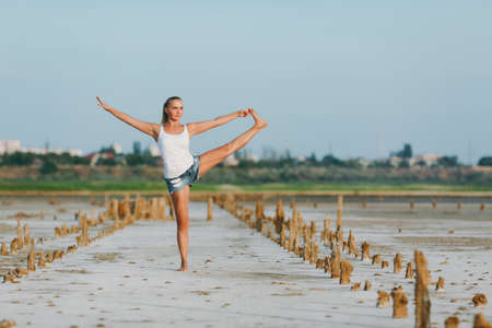 The pretty woman doing yoga on the ground outdoorsの写真素材