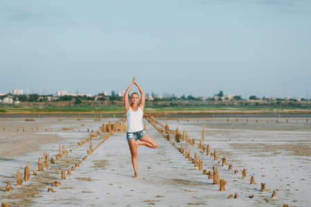 The pretty woman doing yoga on the ground outdoorsの写真素材