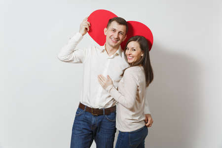 Couple in love. Man and woman with big red heart isolated on white background. Copy space for advertisement. With place for text. St. Valentine's Day International Women Day birthday holiday conceptの写真素材