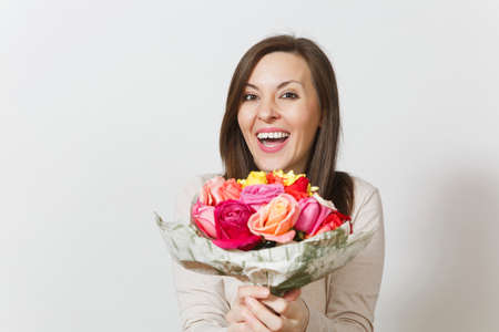 Young smiling woman holding bouquet of beautiful roses flowers isolated on white background. Copy space for advertisement. With place for text. St. Valentines Day or International Women's Day conceptの写真素材