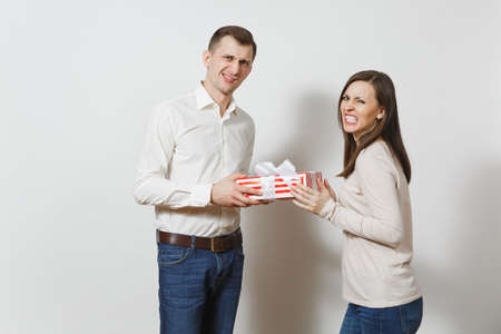 Cute couple in love. Man giving woman present box with gift isolated on white background. Copy space for advertisement. St. Valentine's Day, International Women's Day, birthday, holiday conceptの写真素材