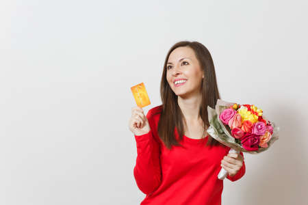 Young beautiful smiling woman holding bouquet of beautiful roses flowers credit card isolated on white background. Copy space for advertisement. St. Valentines Day or International Womens Day conceptの写真素材
