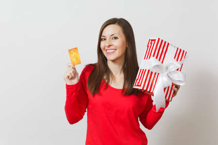 Beautiful woman holding credit card, red present box with gift isolated on white background. For advertisement. St. Valentine's Day, International Women's Day, Christmas, birthday, holiday conceptの写真素材