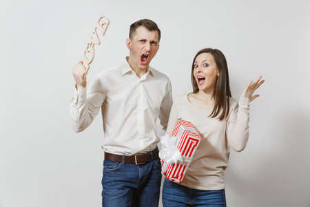 Couple, man, woman with word Love, present box with gift isolated on white background. St. Valentine's Day International Women's Day birthday holiday concept. Quarrel divorce break up of relationshipの写真素材