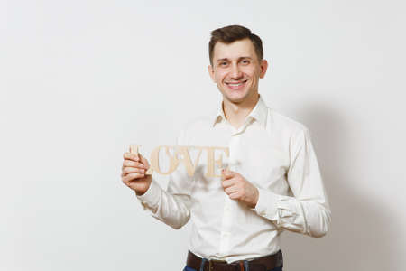 Young handsome man in suit holding big red heart isolated on white background. Copy space, advertisement. Place for text. St. Valentine's Day, International Women's Day, birthday, holiday conceptの写真素材