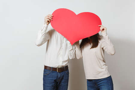 Couple in love. Man and woman with big red heart isolated on white background. Copy space for advertisement. With place for text. St. Valentine's Day International Women Day birthday holiday conceptの写真素材
