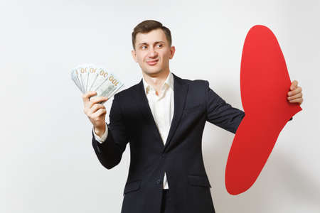 Dissatisfied man with big red heart, bundle of cash money dollars isolated on white background. Copy space for advertisement. St. Valentine's Day, International Women's Day, birthday holiday conceptの写真素材