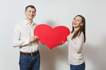 Couple in love. Man and woman with big red heart isolated on white background. Copy space for advertisement. With place for text. St. Valentine's Day International Women Day birthday holiday conceptの写真素材