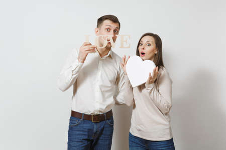 Couple in love. Man, woman with word Love, big white heart isolated on white background. For advertisement. With place for text. St. Valentine's Day, International Women Day birthday holiday conceptの写真素材