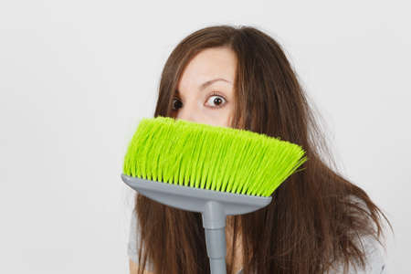 Close up of young fun crazy dizzy loony wild scared housewife with tousled hair isolated on white...