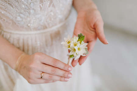 Morning preparation newlyweds for the wedding. Hands of the bride in an elegant lace wedding dress...