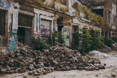 Odessa, Ukraine, 10-12-2017:Industrial building of with graffiti and street art on shabby walls and piles of bricks destroyed as war, earthquake, bomb, terrorist attack or natural disaster concept.のeditorial素材