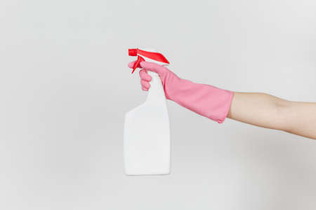Close up of female hand in pink gloves click on white spray bottle with cleaner liquid with place for text isolated on white background. Cleaning supplies concept. Copy space for advertisement.の写真素材