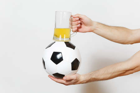 Male hands horizontal holding soccer classic white black ball, pint mug of beer isolated on white...